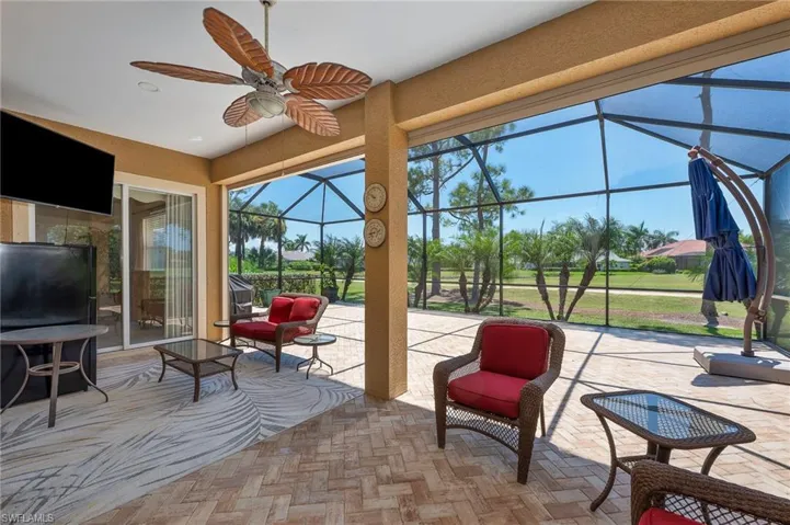 Sunroom featuring a patio area and a ceiling fan