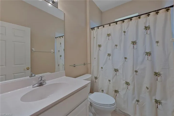 Bathroom featuring vanity and curtained shower