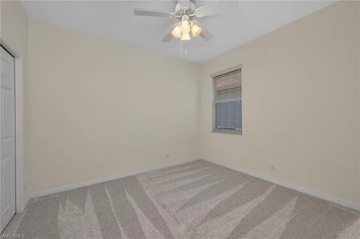 Bedroom with carpet, ceiling fan, and a closet