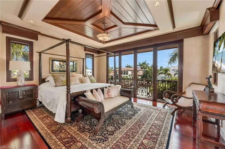 Bedroom with access to outside, dark wood-type flooring, wood ceiling, and crown molding
