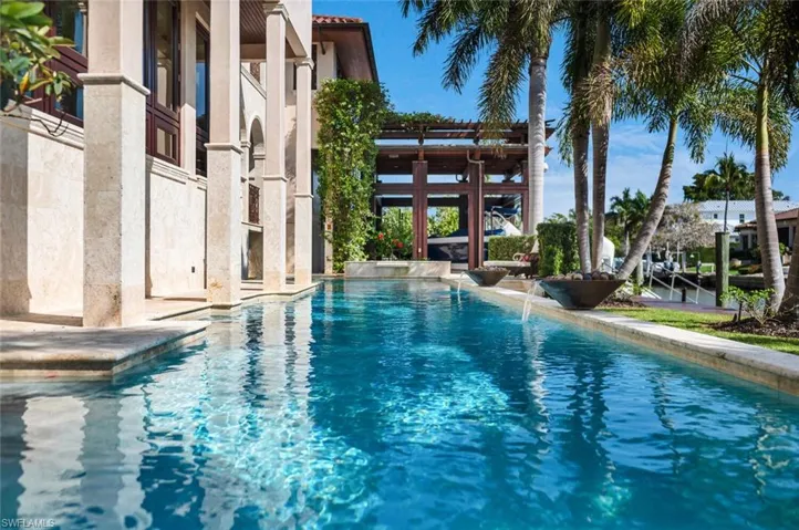 Swimming pool featuring a pergola and a patio