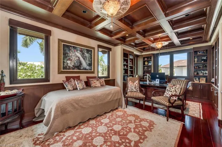 Bedroom with ornamental molding, a desk, coffered ceiling, beamed ceiling, and hardwood / wood-style floors