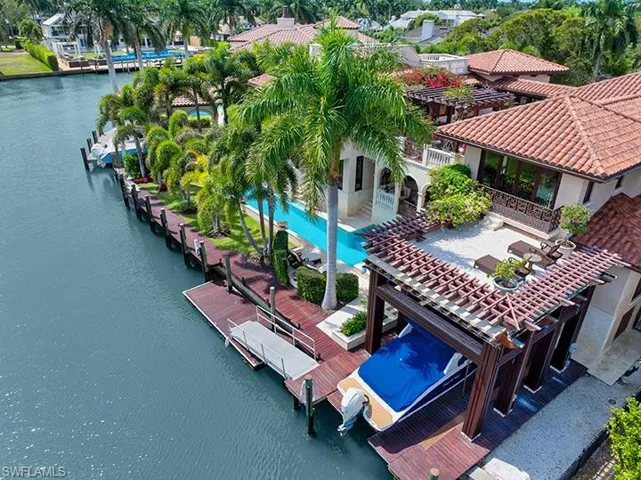 Bird's eye view of a nearby body of water and a pool area