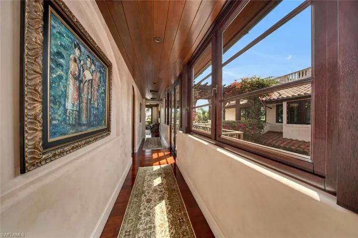 Hall featuring dark wood-style floors and wooden ceiling