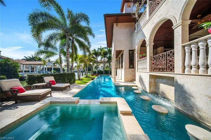 View of pool with a pool with connected hot tub and a patio