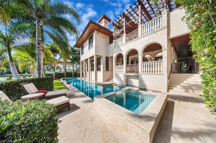 View of pool featuring a patio, a balcony, and a pool with connected hot tub
