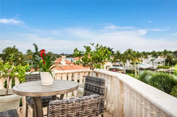 Balcony with a water view and outdoor dining area