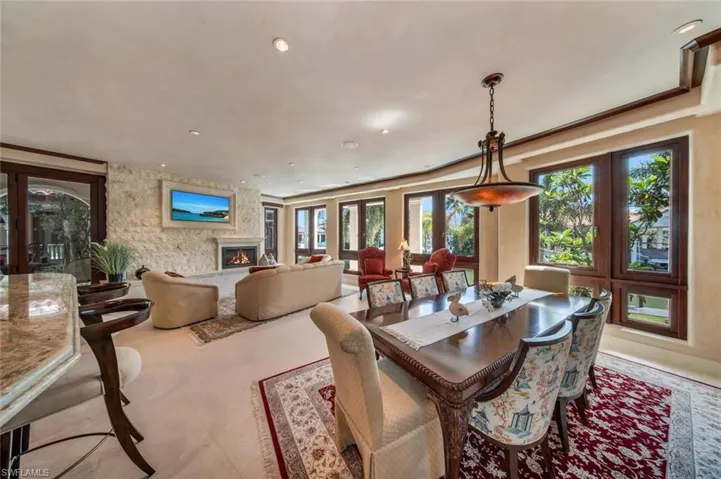 Dining space with a fireplace, recessed lighting, and french doors