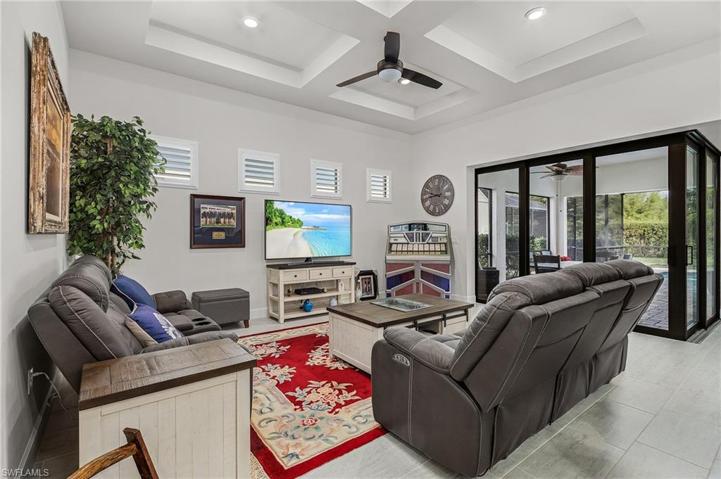 Great room with tray ceiling and ceiling fan