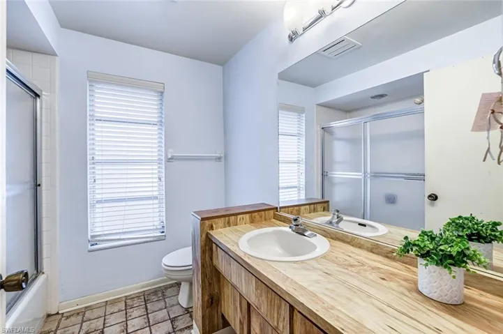 Guest bathroom with enclosed tub / shower combo