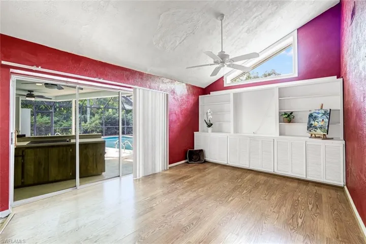 Lofted ceiling in this family room with builit in cabinets and book shelves.