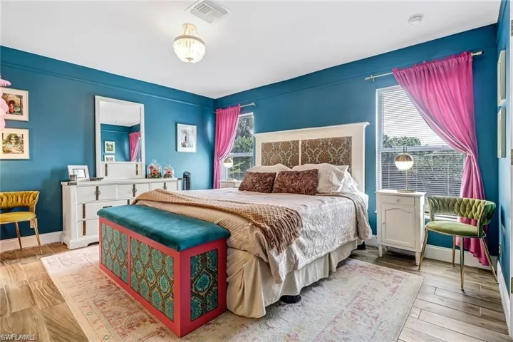 Bedroom with wood finished floors and baseboards