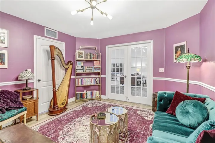 Living area featuring wood finished floors and a chandelier