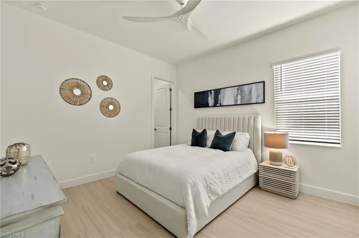 Guest Bedroom 2 - Suite with walk-in closet, pocket door to bathroom, & ceiling fan