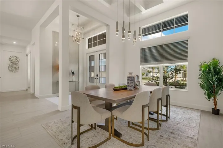 Formal Dining room featuring a Custom Tray Ceiling and Chandelier
