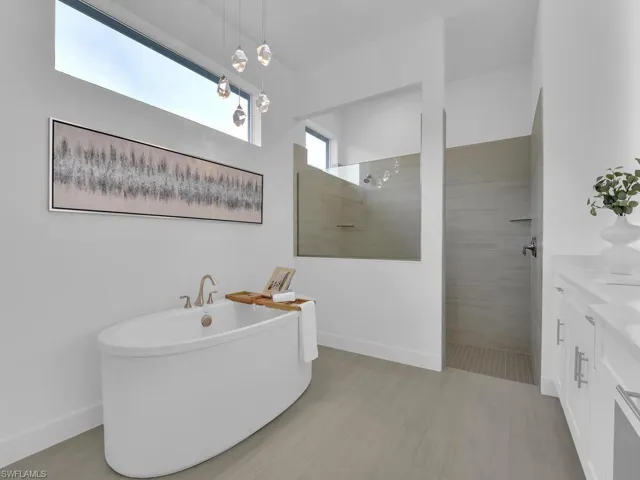 Master Bathroom - Separate Garden Tub and Walk-in Tile Shower with Multiple Shower Heads, Custom Mirrors, Quartz Counters, Dual Sinks, Chandelier, & Private Toilet