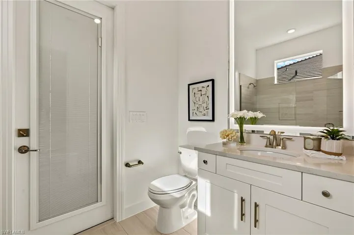 Guest Bathroom 2 with Pool Access, Quartz Counter, Custom Mirror to Ceiling, Walk-in Tile Shower & Framless Shower Door