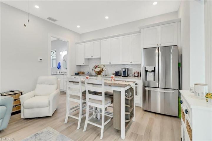 Guest Suite 2 - Kitchen. Features a French-Door Refrigerator, Microwave Oven, Sink & Cabinetry.