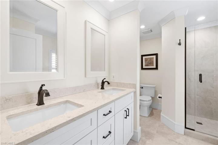 Primary Bathroom featuring dual sinks and walk-in shower