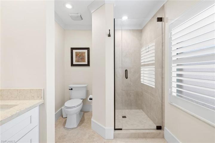 Primary Bathroom featuring dual sinks and walk-in shower