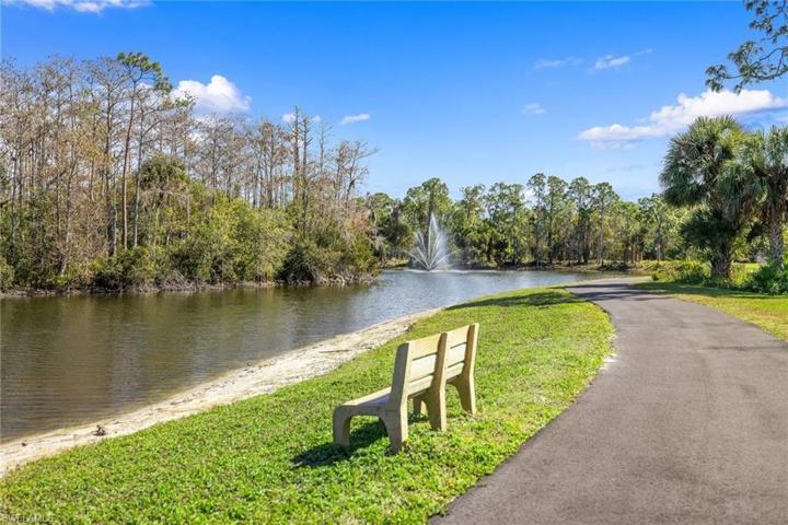 View of lake on sidewalk behind Condo