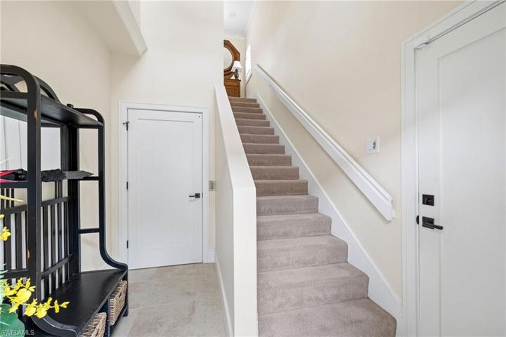 Spacious downstairs foyer facing stairs and garage entry