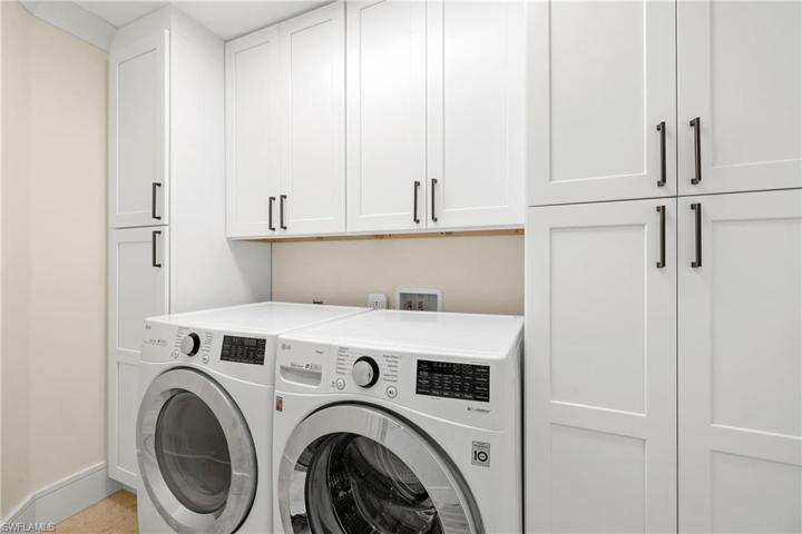 Washer + Dryer in designated room with ample storage space