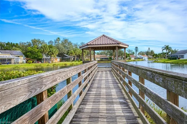 View of dock with a gazebo and a water view