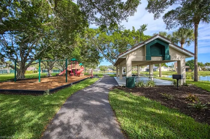 View of home's community with playground community and a yard