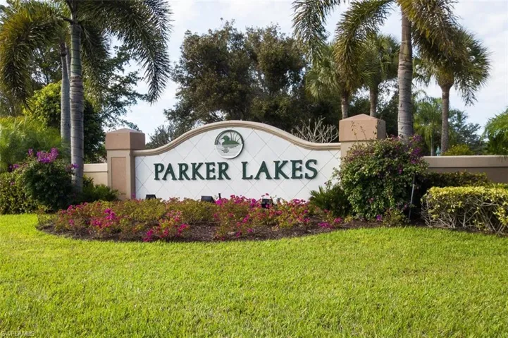 Community / neighborhood sign featuring a yard