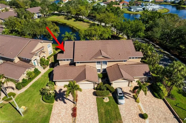 Drone / aerial view with a residential view and a water view
