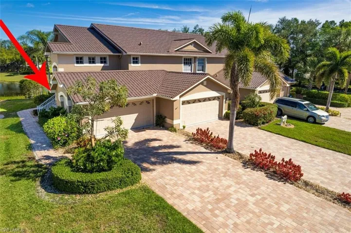 View of front of house with stucco siding, a front lawn, decorative driveway, a garage, and a tiled roof