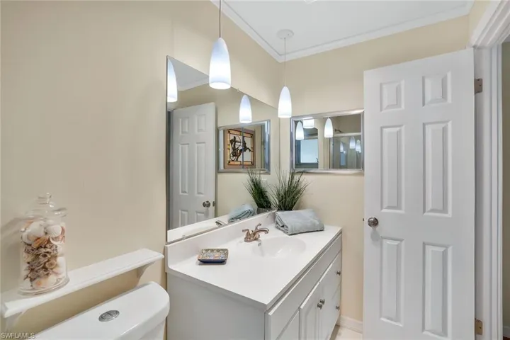 Bathroom featuring ornamental molding, and vanity