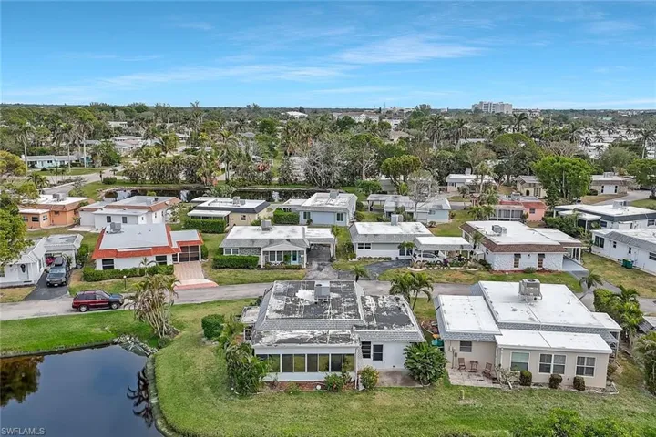 Birds eye view of property with a water view