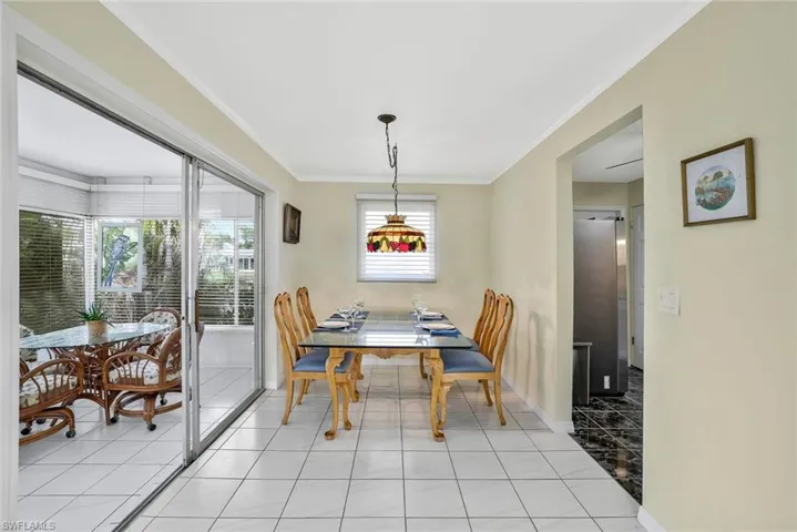 Dining room featuring ornamental molding, plenty of natural light, and light tile patterned floors