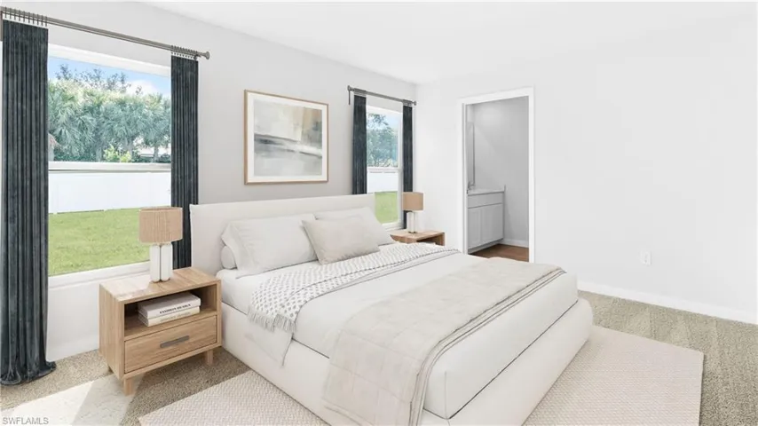 This home is virtually staged. Bedroom featuring connected bathroom and carpet