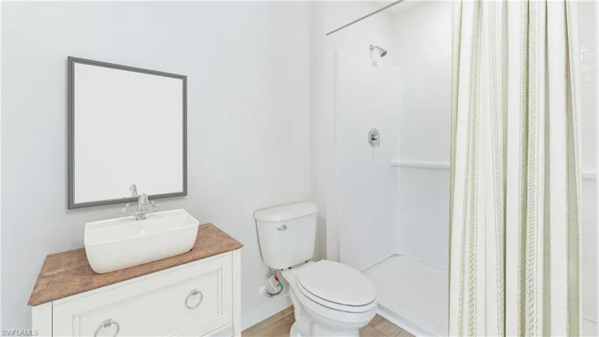 This home is virtually staged. Full bathroom featuring vanity and a shower stall