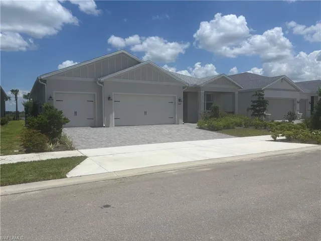 front view of home with covered porch and 3 car garage