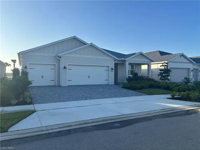 Front view of home with paver driveway and 3 car garage