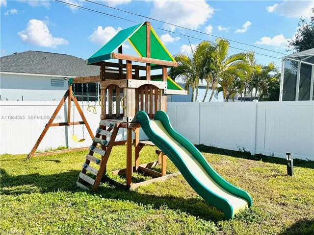 View of playground featuring a fenced backyard