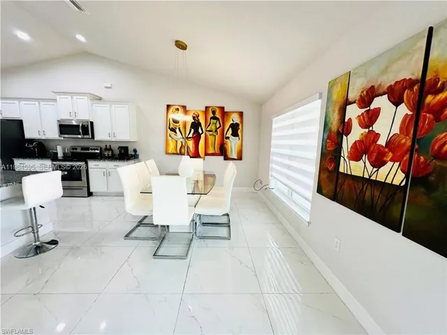 Dining area featuring baseboards and light marble finish flooring