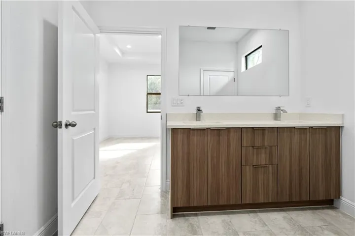 Bathroom with double vanity and healthy amount of natural light