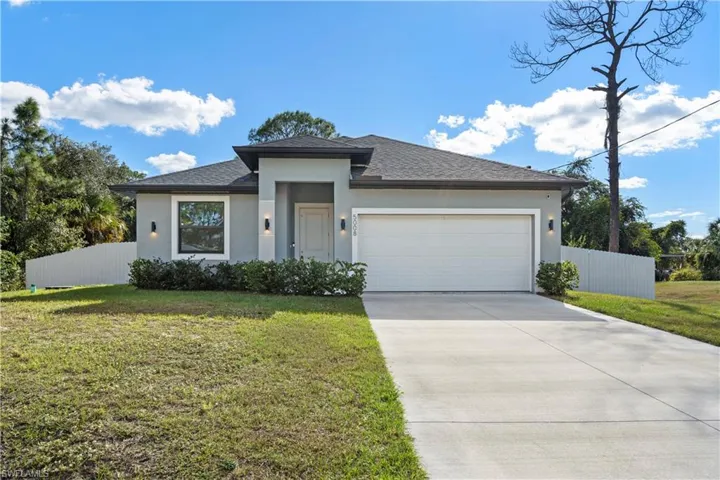 Prairie-style house with stucco siding, driveway, a garage, and a shingled roof