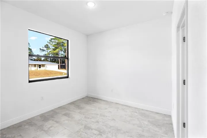 Spare room featuring baseboards and recessed lighting