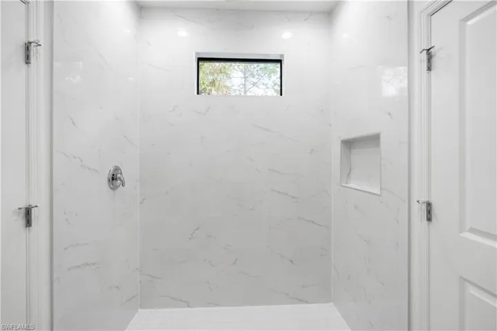 Bathroom with a marble finish shower
