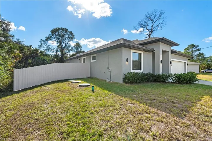 View of property exterior with stucco siding and a garage