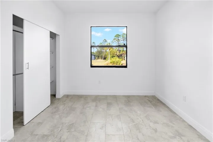 Unfurnished bedroom with baseboards and a closet