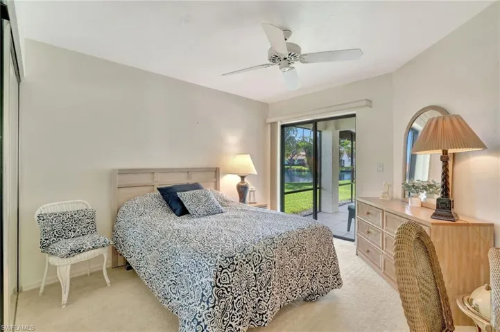 Bedroom featuring light colored carpet, access to outside, and a ceiling fan