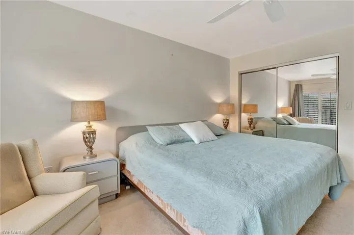 Carpeted bedroom with a closet and ceiling fan