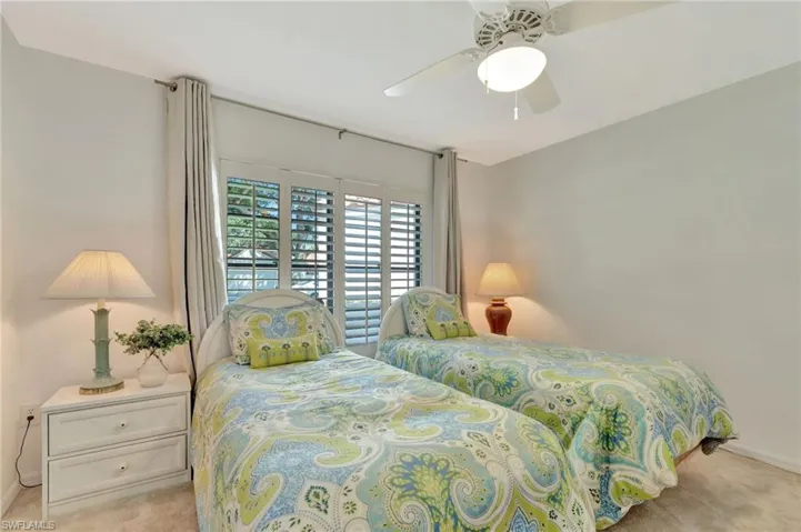 Bedroom featuring light colored carpet and a ceiling fan